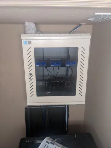 May 2022. A wall-mount cabinet goes up above the rack for the network gear.