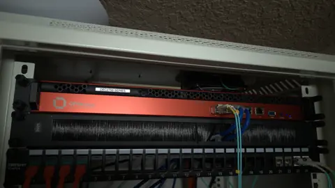 Jan 2026. OPNsense on a Deciso DEC2700 at the top of the wall cabinet, over a keystone patch panel. It arrived in May 2025, five days before the fiber internet that now lands on its SFP+ port.